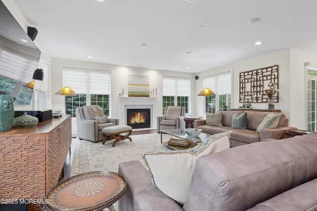 a living room with furniture a fireplace and window