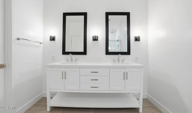 a bathroom with a double vanity sink and mirror