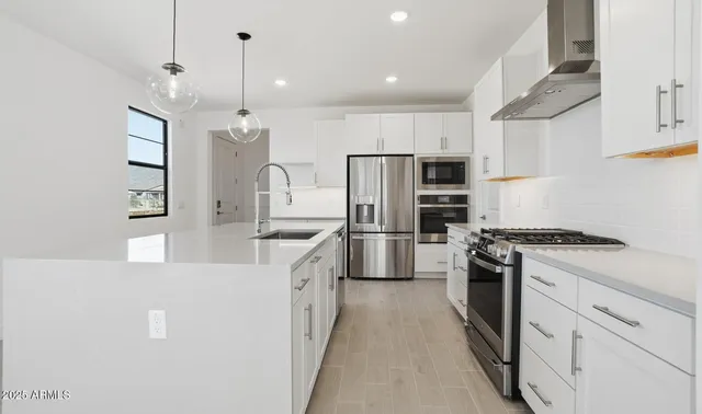 a kitchen with center island and stainless steel appliances