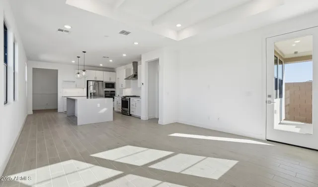a kitchen with stainless steel appliances a refrigerator sink and microwave