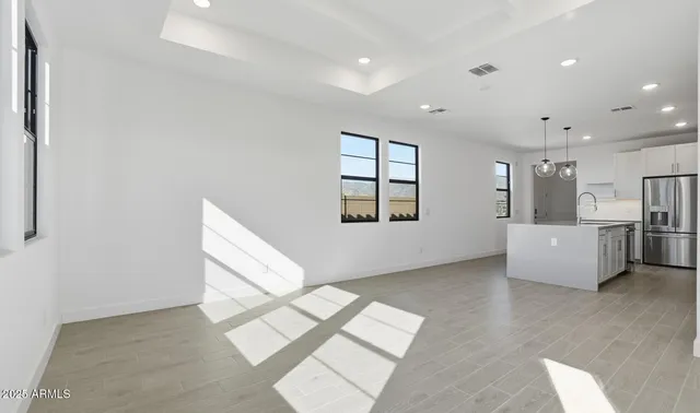 a view of a kitchen with a sink and cabinets