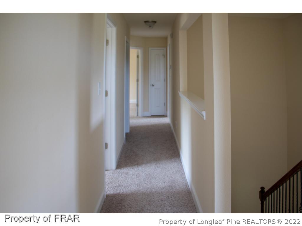 5219 Sunset View Road Hope Mills, NC 28348 - Photo 15 of 24 a view of a hallway with wooden floor