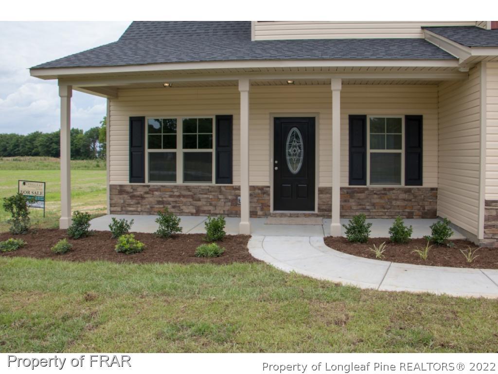 5219 Sunset View Road Hope Mills, NC 28348 - Photo 3 of 24 a front view of a house with a yard