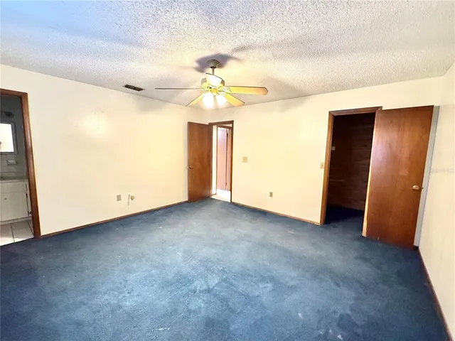 a view of empty room with ceiling fan