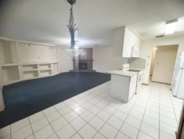 a large white kitchen with cabinets