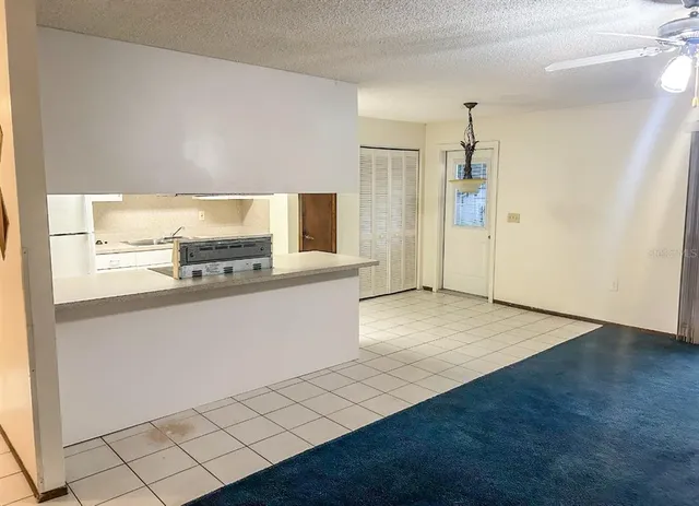 a kitchen with granite countertop a stove a sink and a refrigerator