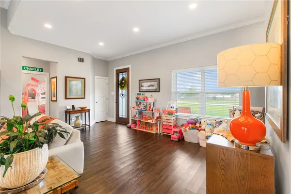 a living room with furniture and a wooden floor