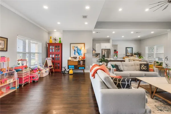 a living room with furniture and a wooden floor