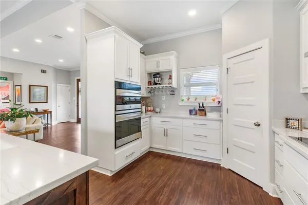 a kitchen with white cabinets and white appliances