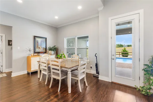 a view of a dining room with furniture window and wooden floor