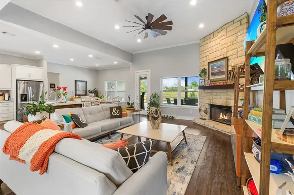 a living room with fireplace furniture and a wooden floor