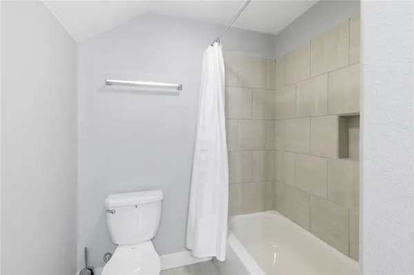 a bathroom with a toilet and bathtub