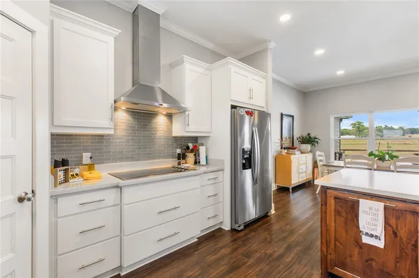 a kitchen with refrigerator and cabinets