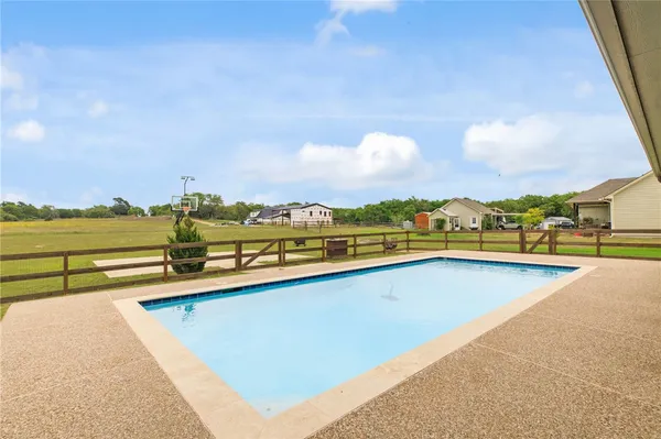 a view of swimming pool with outdoor seating and city view