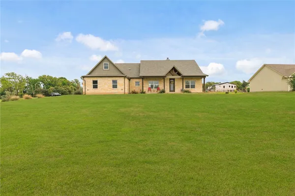 a front view of house with yard and green space