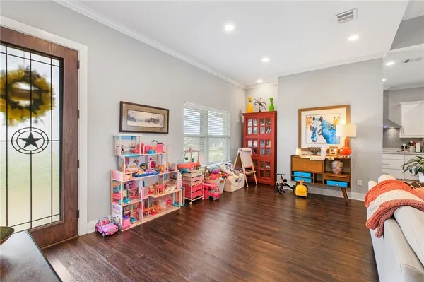 a play room with furniture and wooden floor