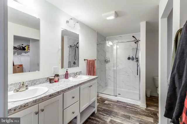 a view of a room with wooden floor and a bathroom