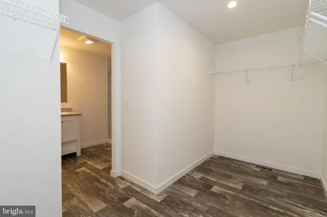 a bathroom with a sink a toilet and a large mirror
