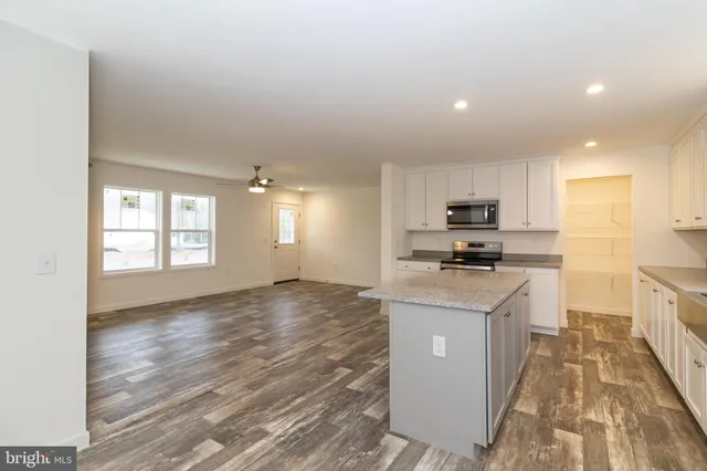 a view of a yard in front of a house with large trees