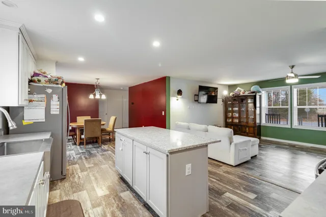 a kitchen with a sink a counter top space appliances and cabinets