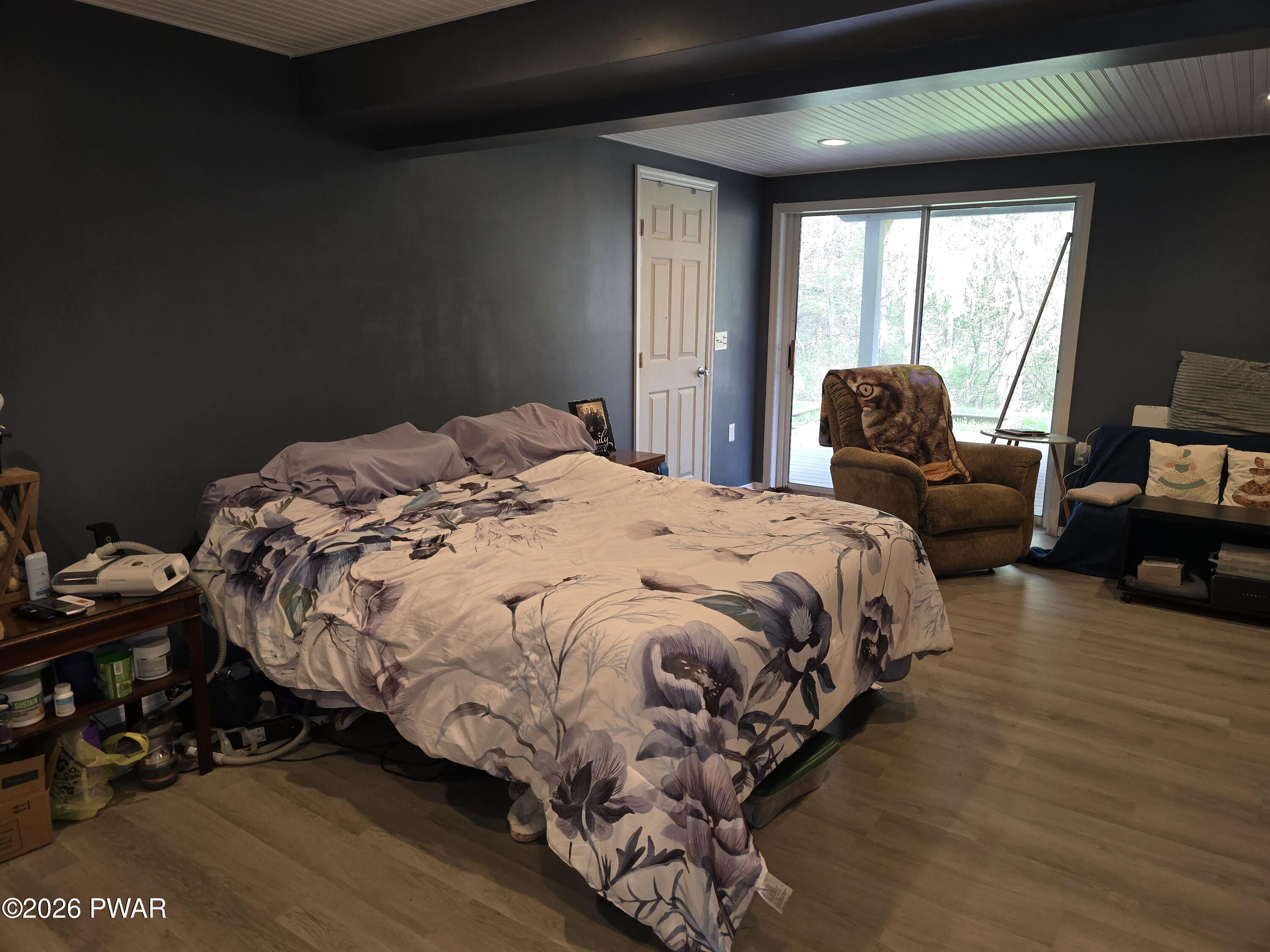 107 Keystone Hls Road, Unit 404 Factoryville, PA 18419 - Photo 10 of 23 a bedroom with a bed and wooden floor