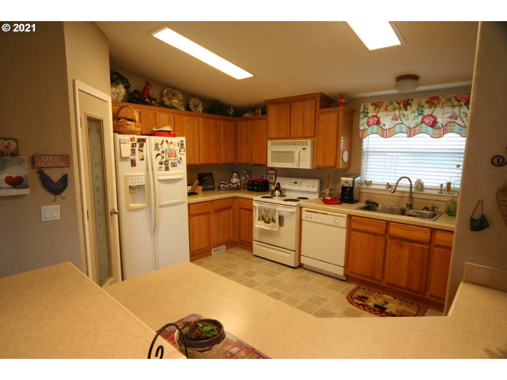 16775 Southeast Fairview Road Dayton, OR 97114 - Photo 6 of 24 a kitchen with stainless steel appliances granite countertop a refrigerator a sink a stove top oven with wooden floor