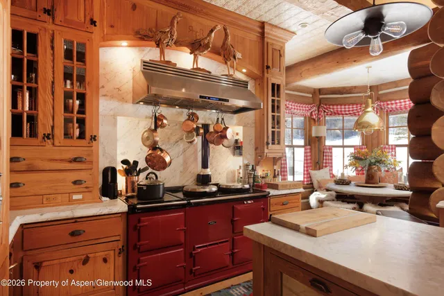 a bedroom with furniture a flat screen tv and a large window