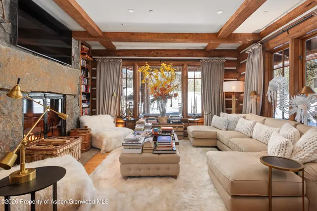 a living room filled with furniture and a large window