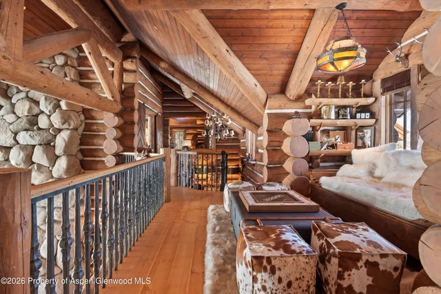 a spacious bedroom with two beds and wooden floor