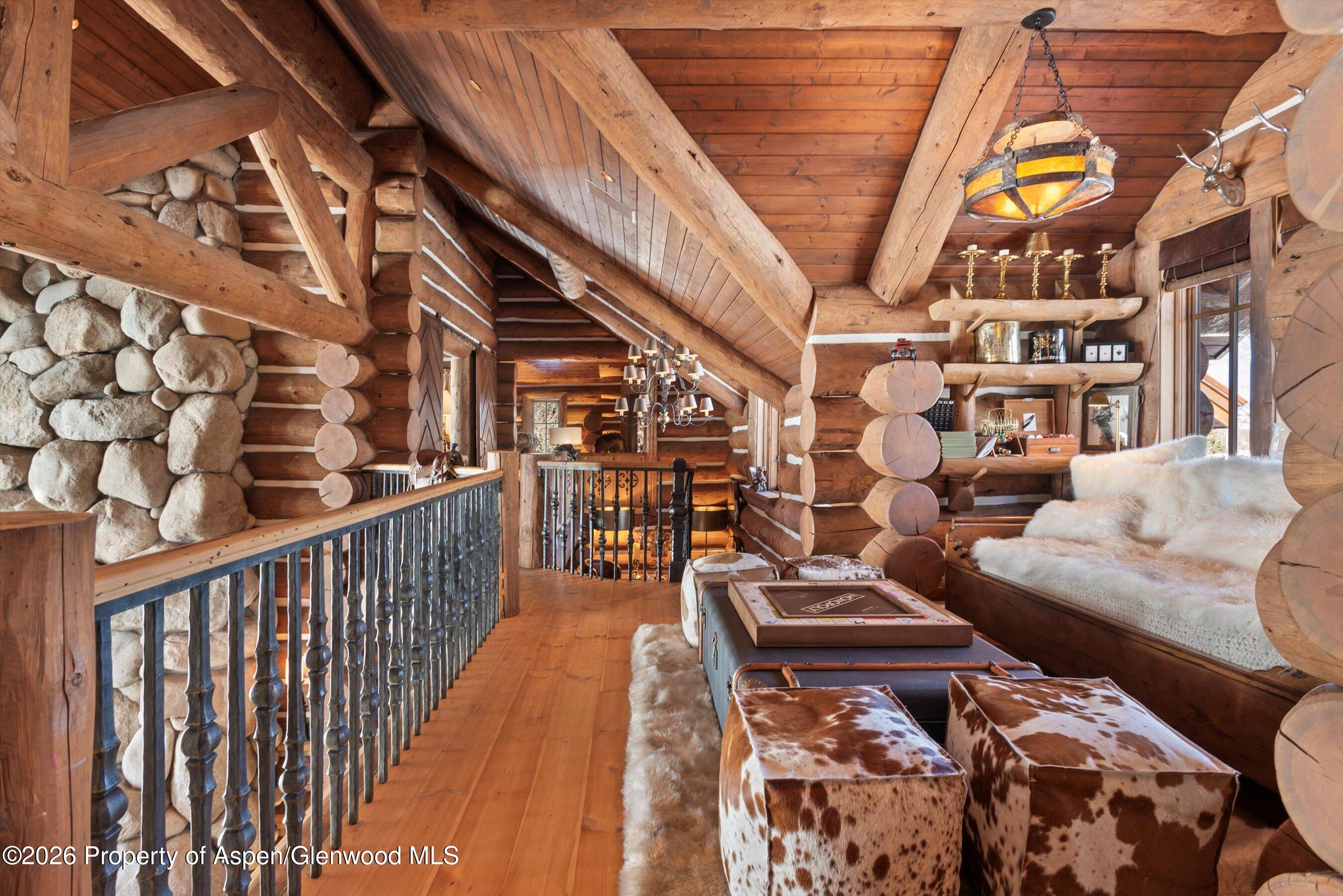 6855 Capitol Creek Road Snowmass, CO 81654 - Photo 25 of 79 a balcony with chairs and wooden floor