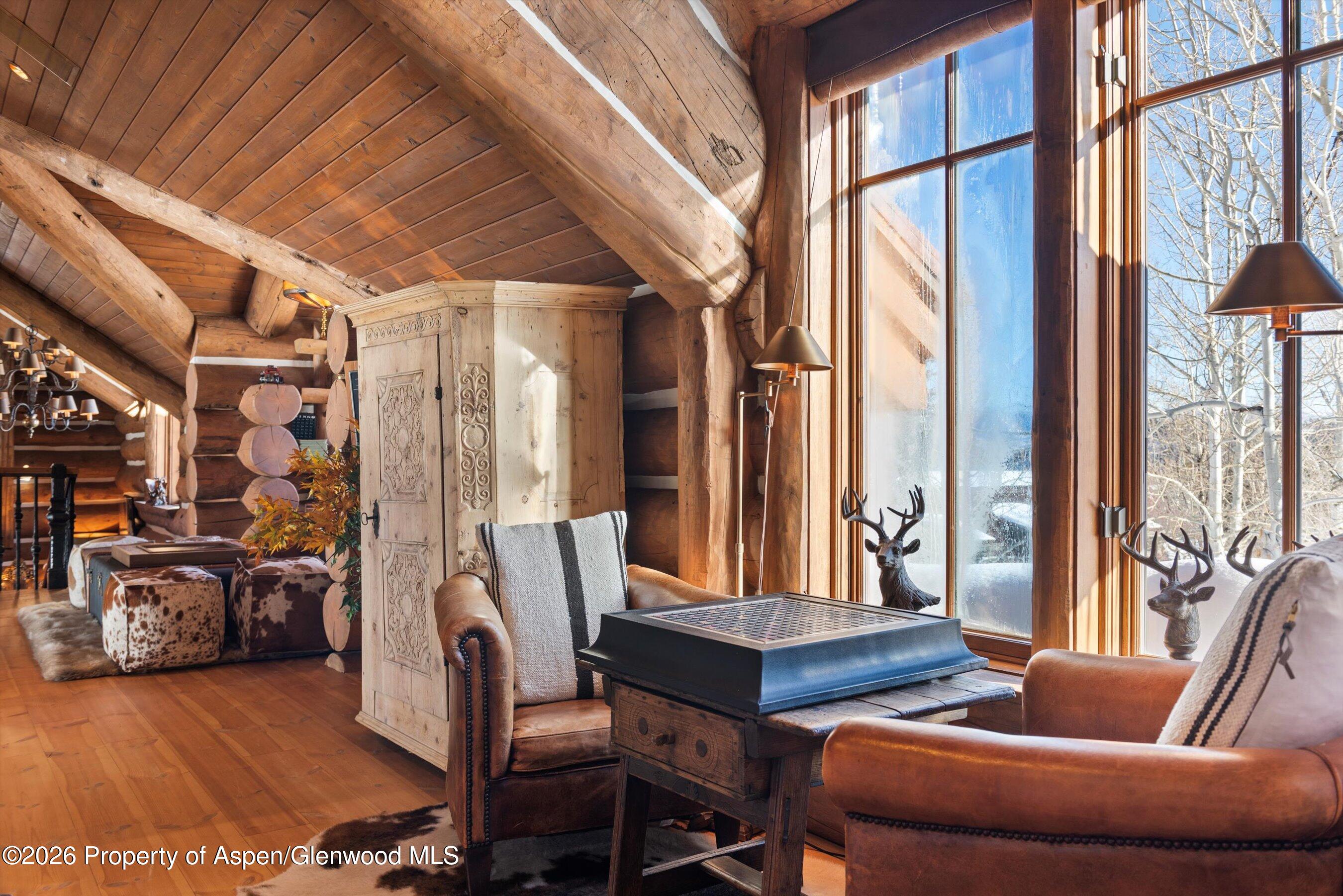 6855 Capitol Creek Road Snowmass, CO 81654 - Photo 26 of 79 a living room with furniture and a large window