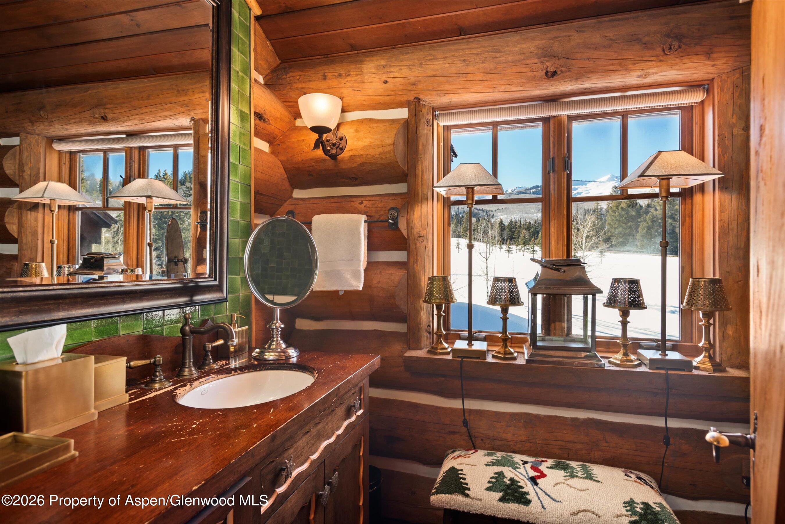 6855 Capitol Creek Road Snowmass, CO 81654 - Photo 31 of 79 a bathroom with a sink and a mirror