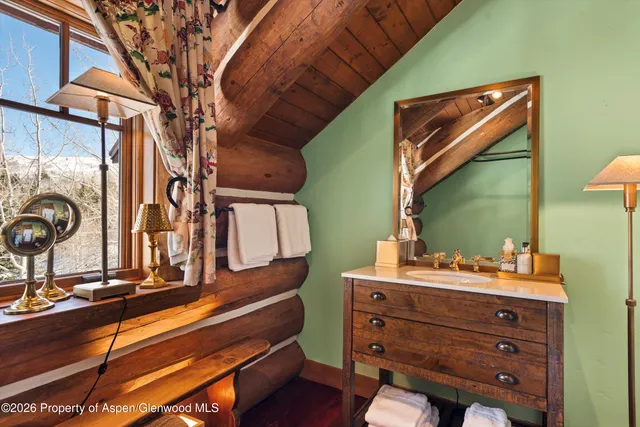 a bed room with furniture and a painting on the wall