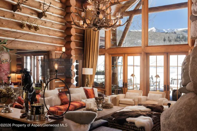 a dining room with furniture a chandelier and a rug