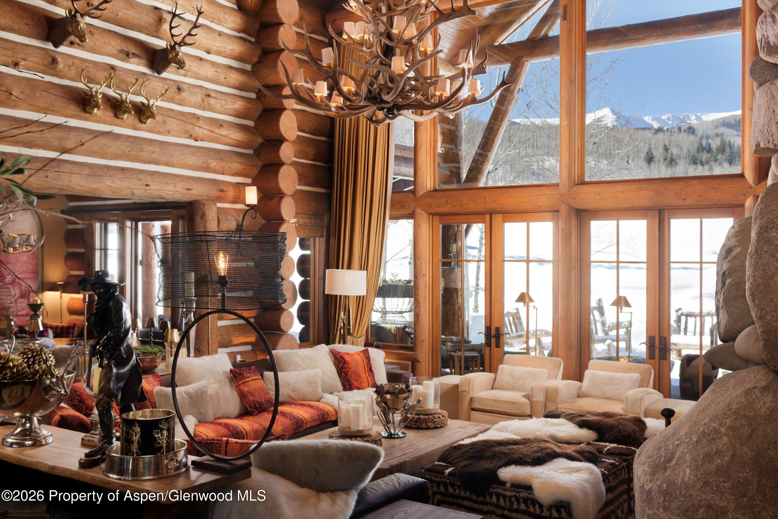 6855 Capitol Creek Road Snowmass, CO 81654 - Photo 6 of 79 a living room with furniture and floor to ceiling windows