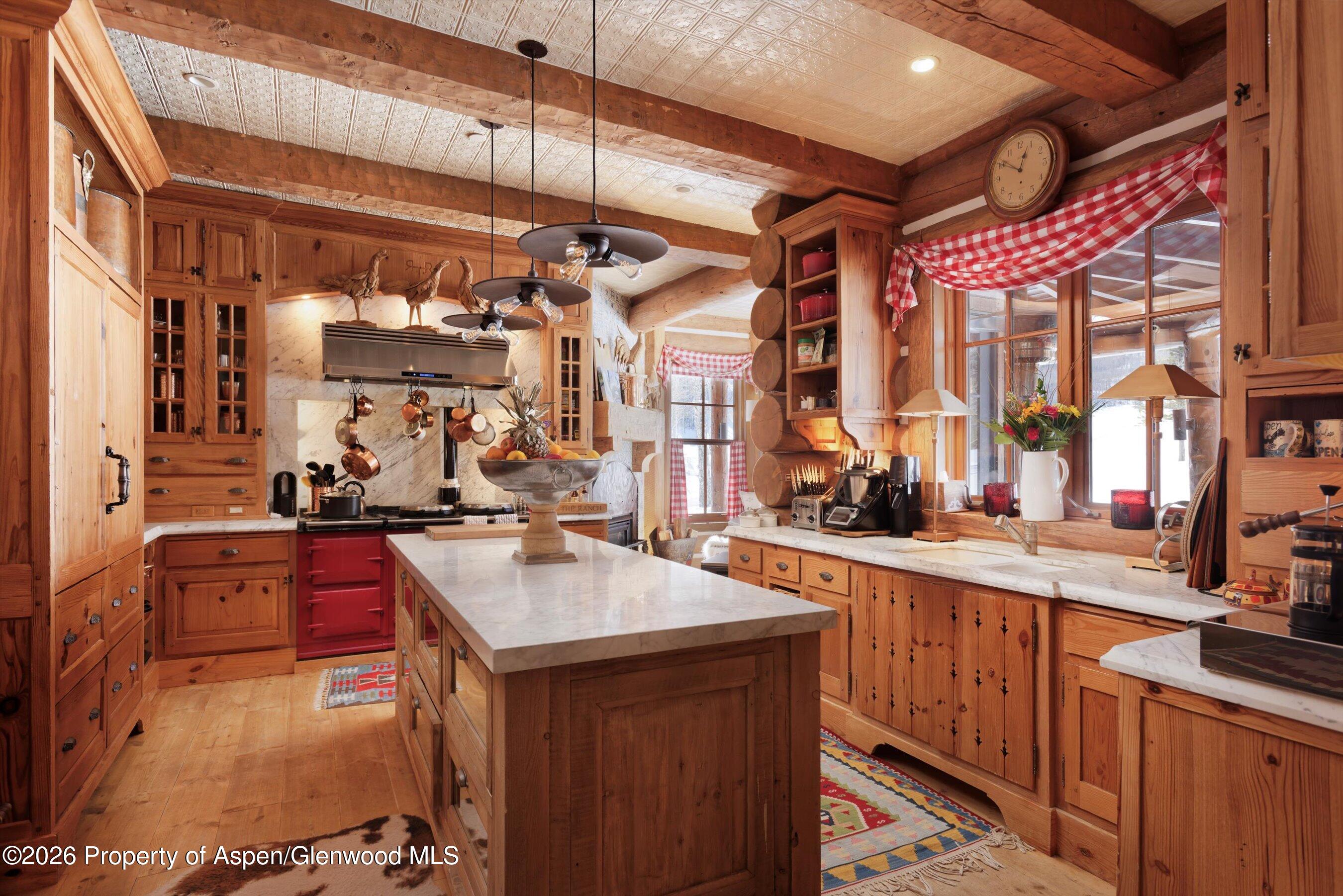 6855 Capitol Creek Road Snowmass, CO 81654 - Photo 10 of 79 a kitchen with a sink stove and cabinets