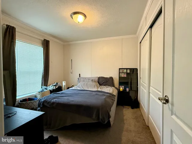 a bedroom with bed and a window