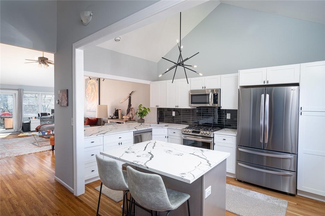 135 West Nyack Road, Unit 96 Nanuet, NY 10954 - Photo 1 of 1 a kitchen with stainless steel appliances a refrigerator a stove a sink a dining table and chairs