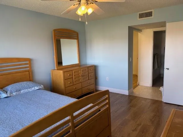 a large bed sitting in a bedroom next to a window