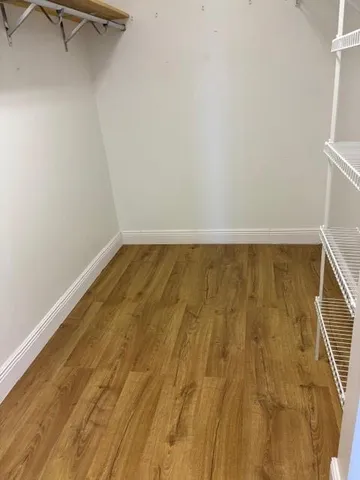 a view of a room that has a bed and a window