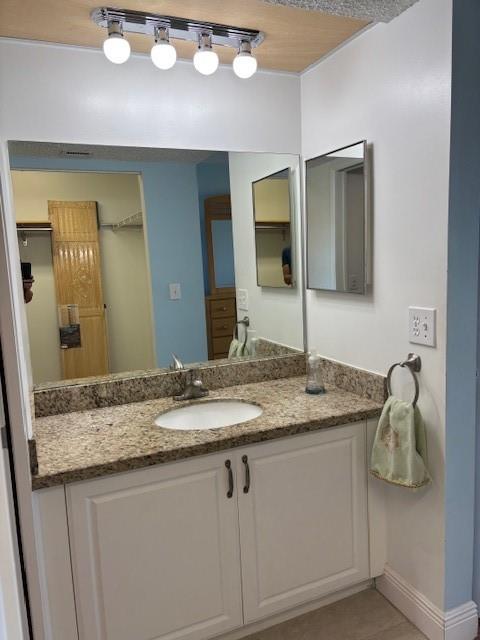 12651 Southwest 16th Court, Unit 413B Pembroke Pines, FL 33027 - Photo 22 of 66 a bathroom with a granite countertop sink and a mirror