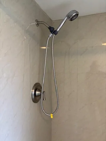 a bathroom with a granite countertop sink a toilet and a shower