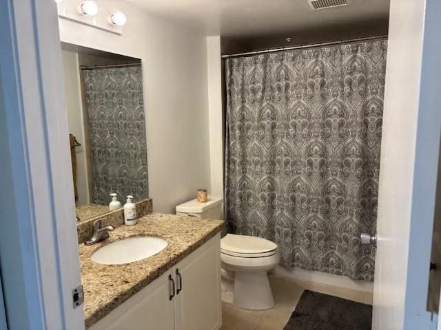 a kitchen with granite countertop a sink and cabinets
