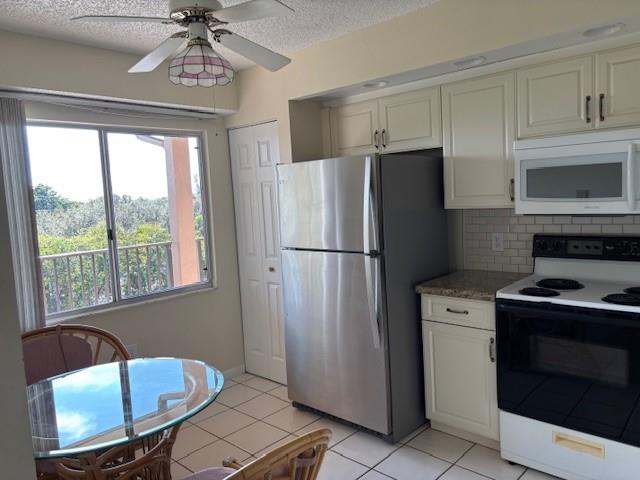 12651 Southwest 16th Court, Unit 413B Pembroke Pines, FL 33027 - Photo 35 of 66 a kitchen with stainless steel appliances granite countertop a refrigerator a sink a stove a washer dryer and a window
