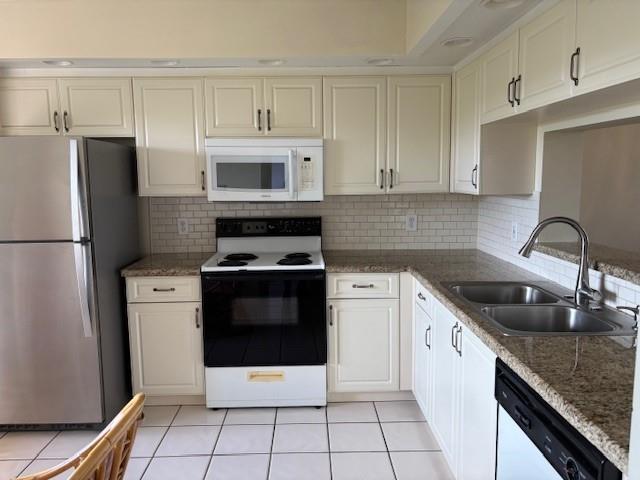12651 Southwest 16th Court, Unit 413B Pembroke Pines, FL 33027 - Photo 37 of 66 a kitchen with granite countertop a sink stove and refrigerator