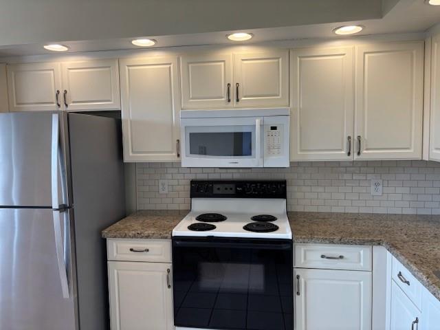12651 Southwest 16th Court, Unit 413B Pembroke Pines, FL 33027 - Photo 40 of 66 a kitchen with a sink stove and refrigerator
