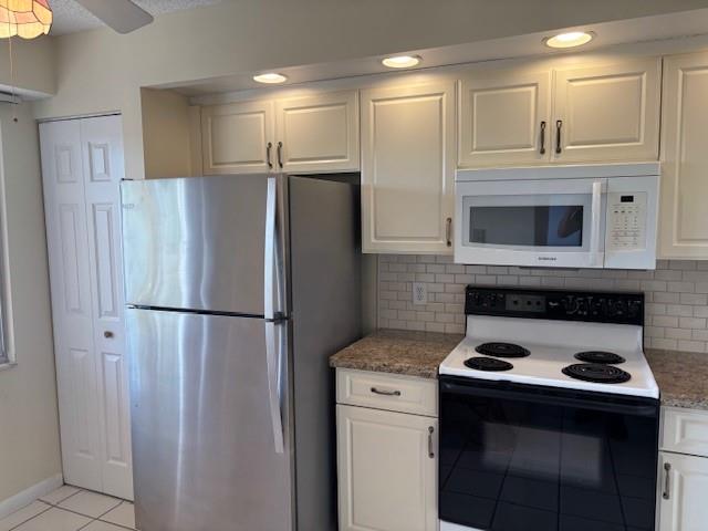 12651 Southwest 16th Court, Unit 413B Pembroke Pines, FL 33027 - Photo 41 of 66 a kitchen with a stove a refrigerator and a cabinets