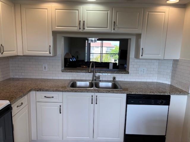 12651 Southwest 16th Court, Unit 413B Pembroke Pines, FL 33027 - Photo 44 of 66 a kitchen with granite countertop white cabinets and a sink