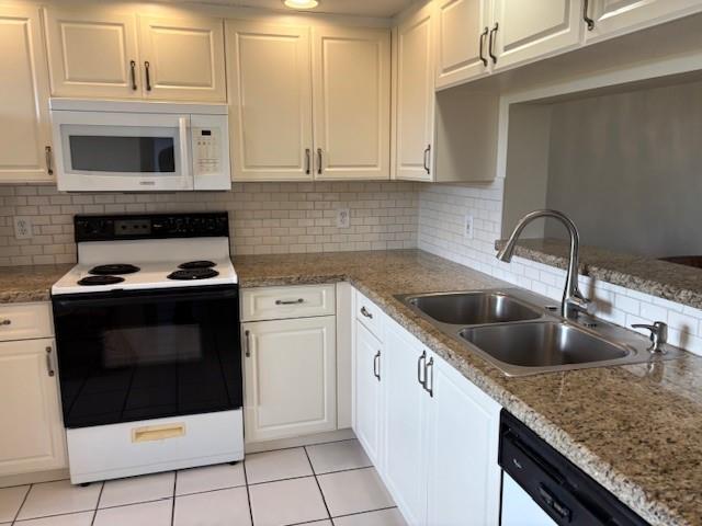 12651 Southwest 16th Court, Unit 413B Pembroke Pines, FL 33027 - Photo 48 of 66 a kitchen with granite countertop a sink a stove and cabinets