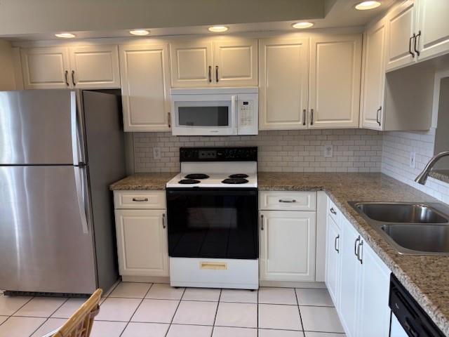 12651 Southwest 16th Court, Unit 413B Pembroke Pines, FL 33027 - Photo 49 of 66 a kitchen with stainless steel appliances granite countertop a refrigerator a stove a sink and a microwave